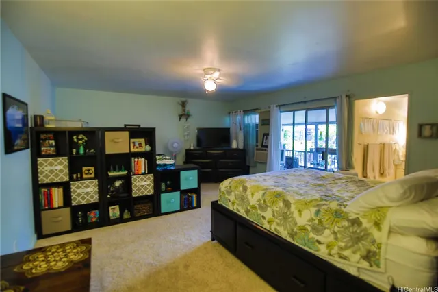 a spacious bedroom with a bed and a flat screen tv