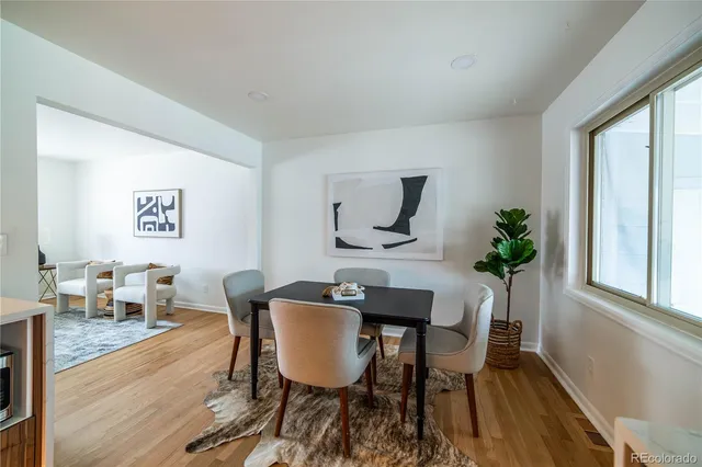 a view of a dining room with furniture window and wooden floor