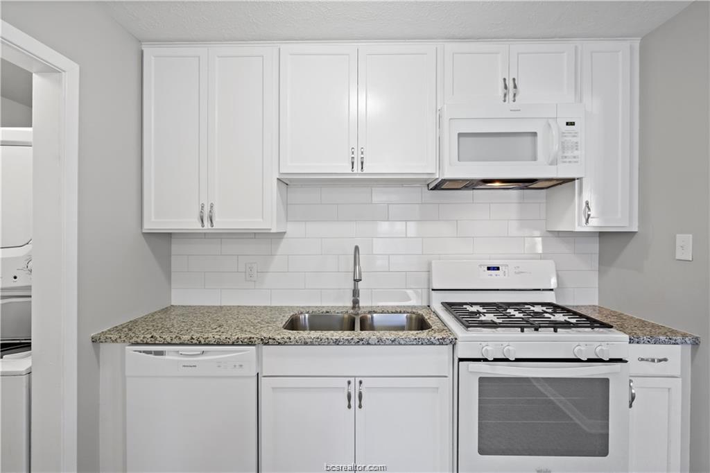 1907 Orman Street Bryan, TX 77801 - Photo 9 of 20 a kitchen with granite countertop white cabinets and white stove