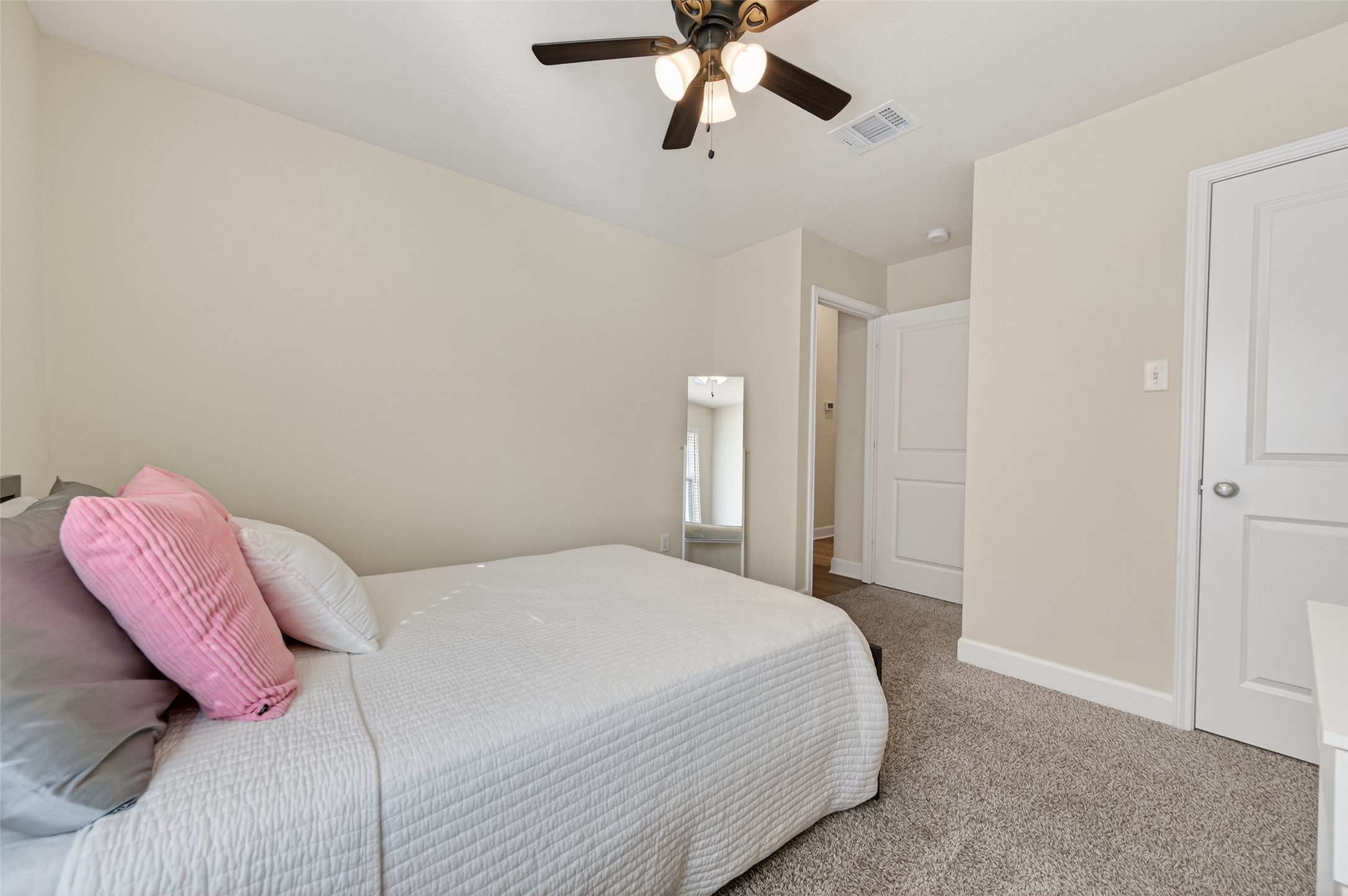 917 Farm Path Brenham, TX 77833 - Photo 34 of 43 a bedroom with a bed and a chandelier