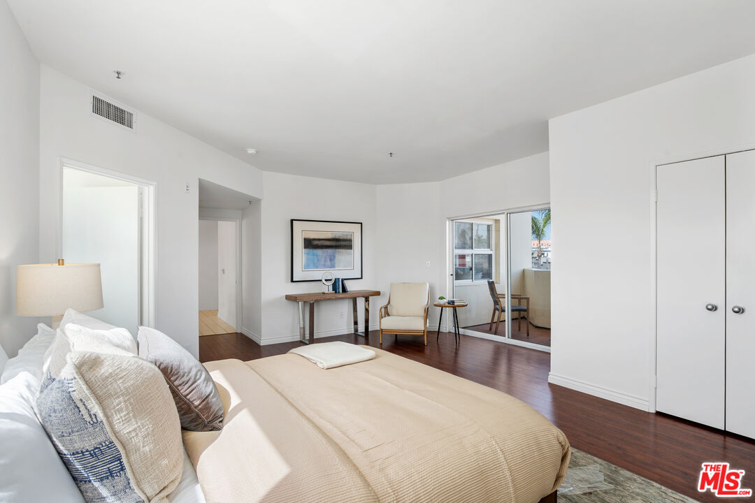 255 Main Street, Unit 101 Venice, CA 90291 - Photo 11 of 28 a bedroom with a bed and wooden floor