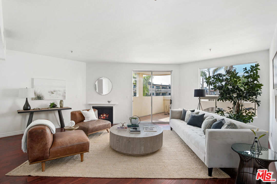 255 Main Street, Unit 101 Venice, CA 90291 - Photo 2 of 28 a living room with furniture a fireplace and a potted plant