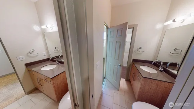 a bathroom with a sink vanity granite and a mirror