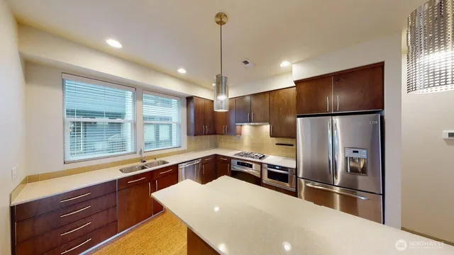 a kitchen with a refrigerator a sink and cabinets