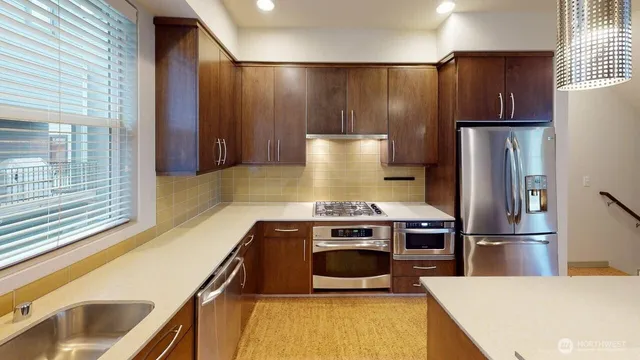 a kitchen with a refrigerator and a sink