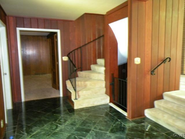 VIEW OF TILED ENTRY TO DEN AND STAIRS TO SECOND FL