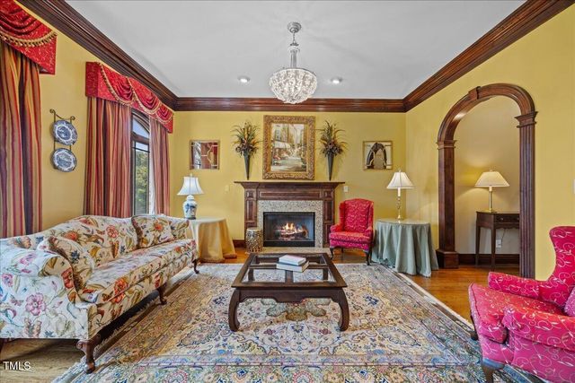 a view of a dining room with furniture wooden floor and chandelier