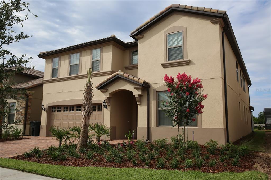 8809 Rhodes Street Kissimmee, FL 34747 - Photo 1 of 49 a front view of a house with garden