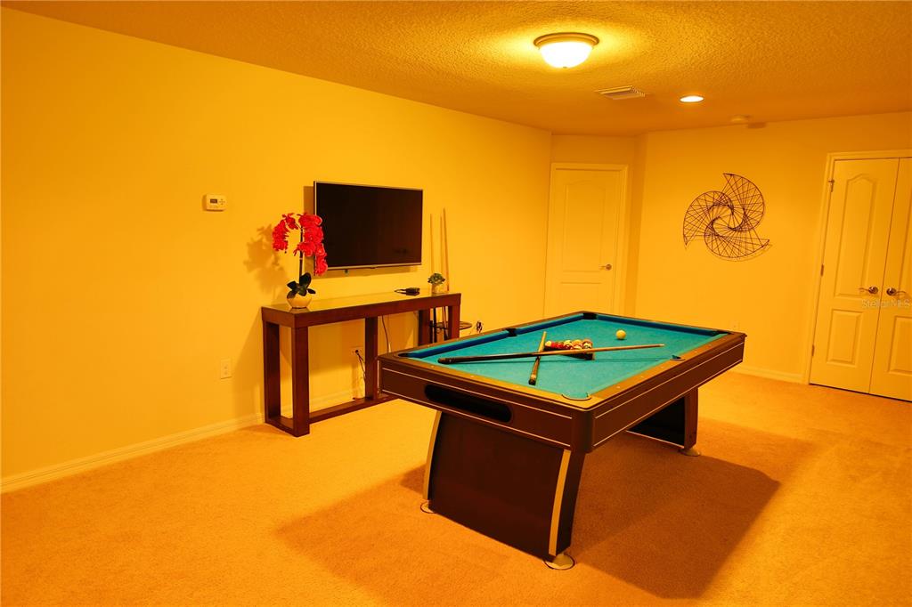 8809 Rhodes Street Kissimmee, FL 34747 - Photo 15 of 49 a room with pool table and a flat screen tv