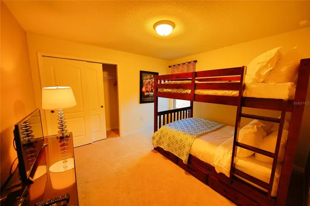 a bedroom with two beds and a dresser