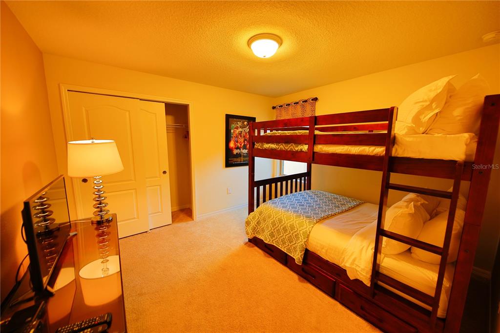 8809 Rhodes Street Kissimmee, FL 34747 - Photo 19 of 49 a bedroom with two beds and a dresser