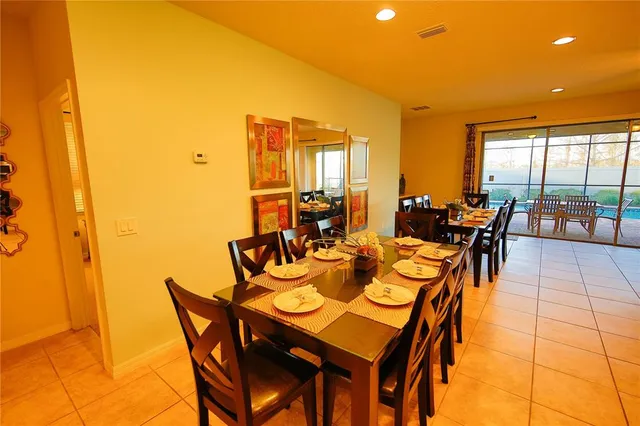 a dining room with furniture and wooden floor