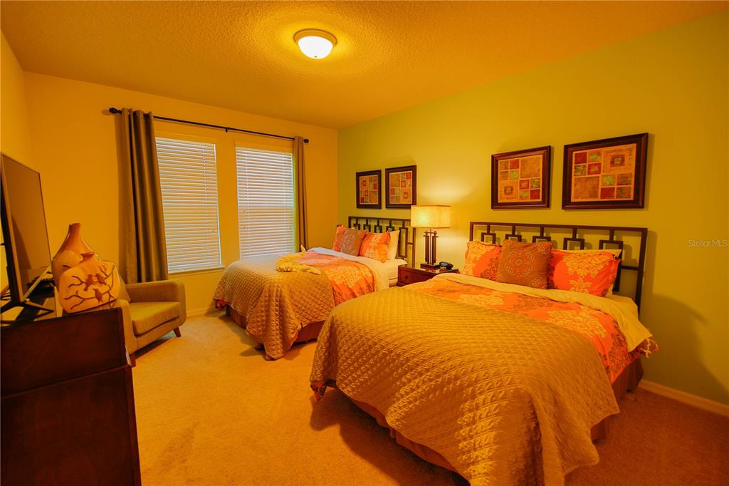 8809 Rhodes Street Kissimmee, FL 34747 - Photo 22 of 49 a bed room with two beds and a large window