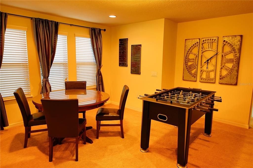8809 Rhodes Street Kissimmee, FL 34747 - Photo 25 of 49 a view of a dining room with furniture and a window