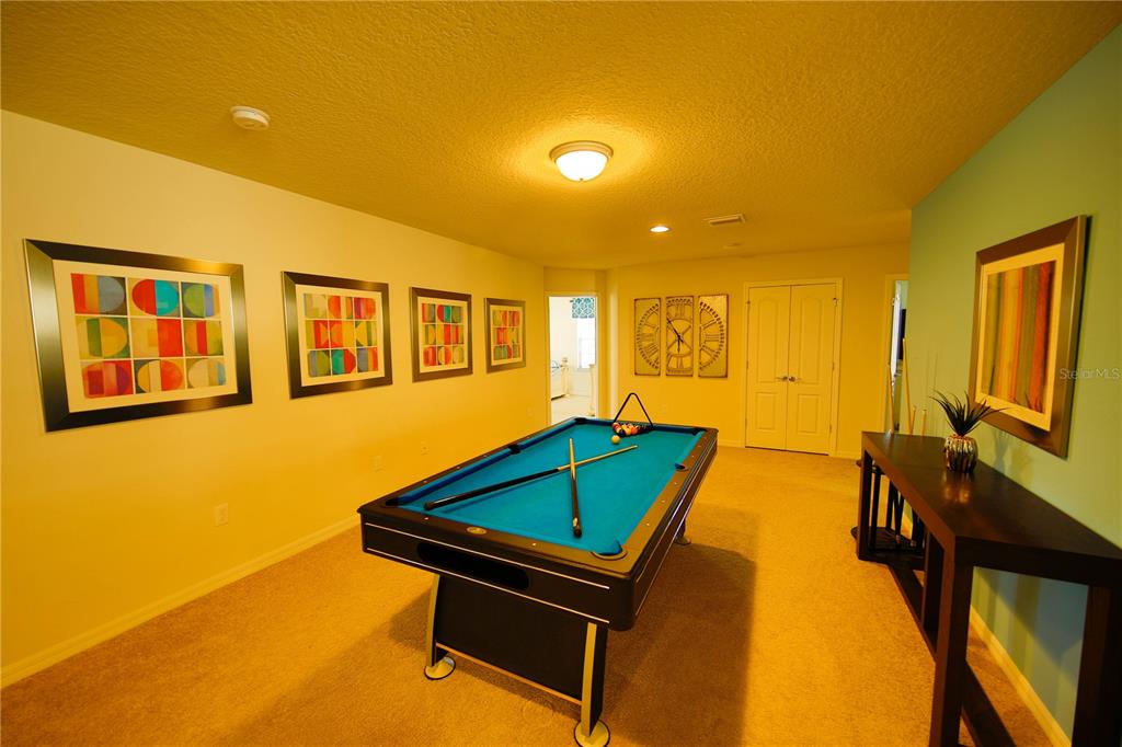 8809 Rhodes Street Kissimmee, FL 34747 - Photo 29 of 49 a room with furniture pool table and a flat screen tv