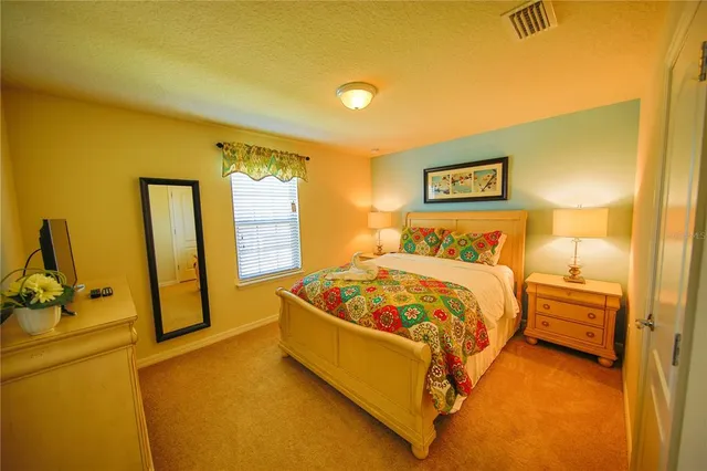 a bedroom with two beds and painting on the wall