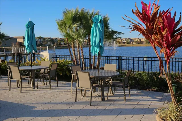 a view of a swimming pool with lounge chairs in patio