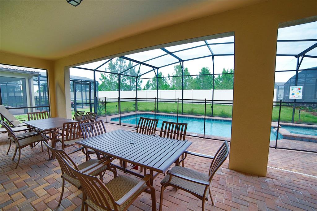 8809 Rhodes Street Kissimmee, FL 34747 - Photo 4 of 49 a view of a city from a dining room with furniture window and wooden floor