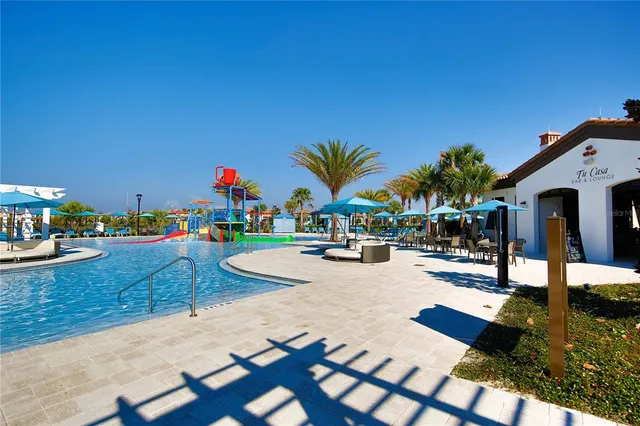 a view of swimming pool with outdoor seating and plants