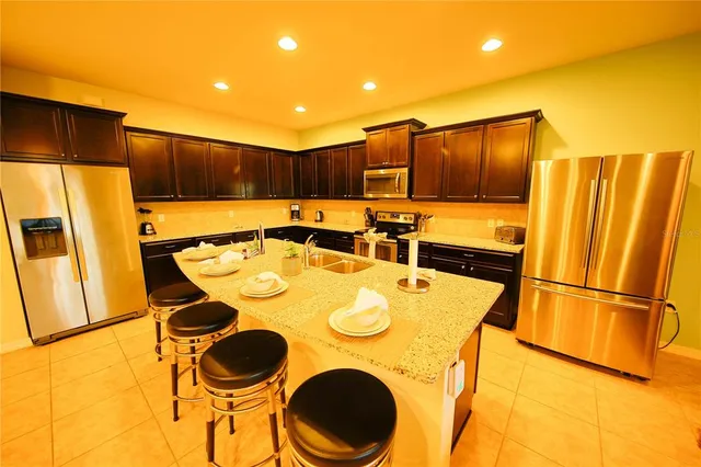a kitchen that has a sink and a refrigerator