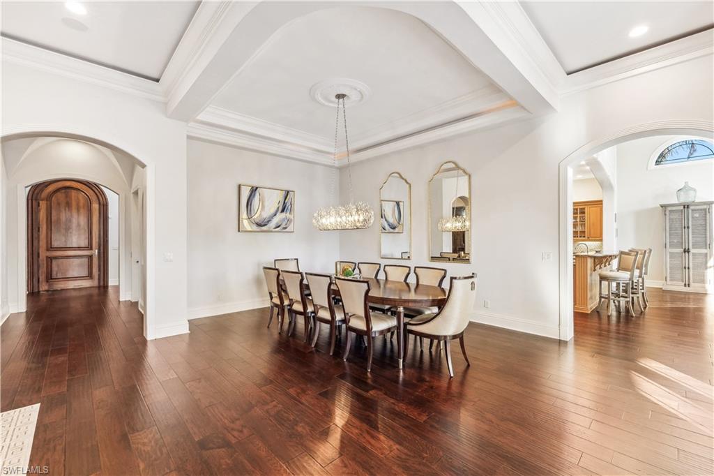 280 Egret Avenue Naples, FL 34108 - Photo 14 of 44 Dining room featuring a chandelier, dark hardwood / wood-style flooring, and crown molding