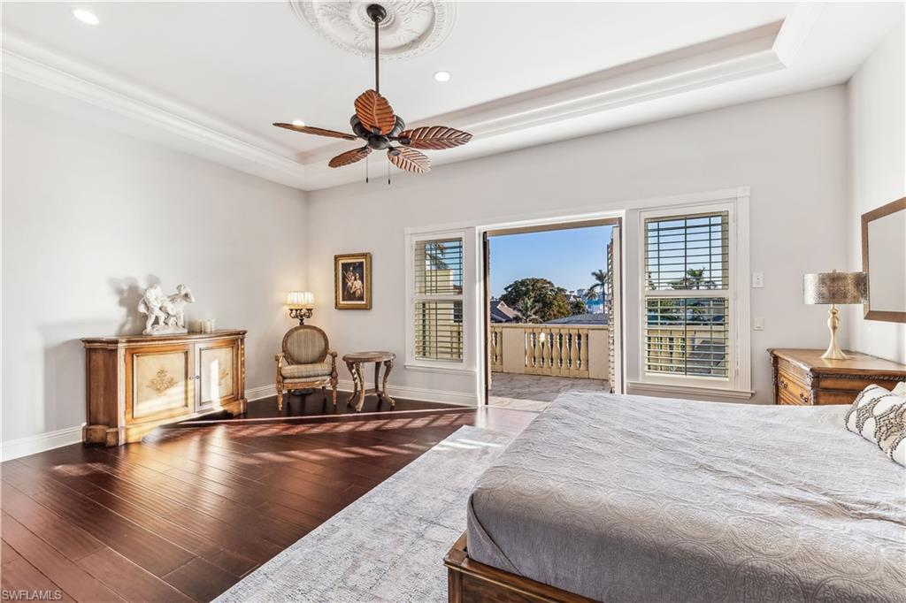 280 Egret Avenue Naples, FL 34108 - Photo 23 of 44 Primary Bedroom with a seating area, tray ceiling, ceiling and doors to your private balcony