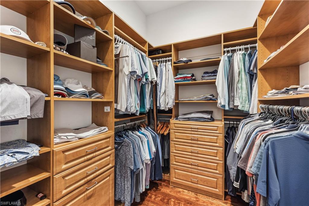 280 Egret Avenue Naples, FL 34108 - Photo 25 of 44 Spacious walk-in closet featuring dark hardwood / wood-style flooring