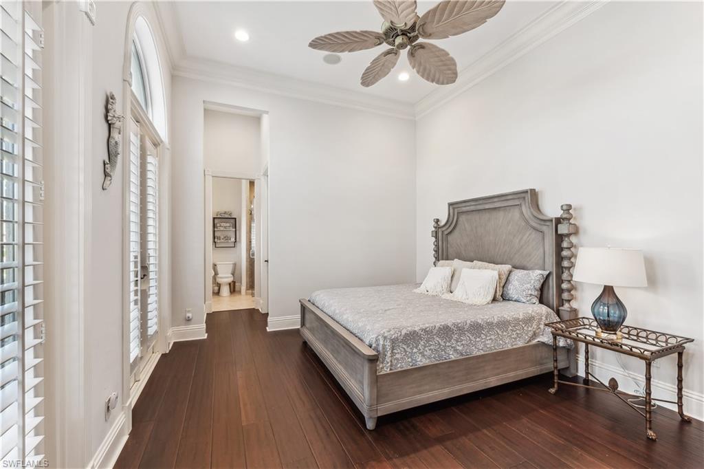 280 Egret Avenue Naples, FL 34108 - Photo 30 of 44 3rd Guest bedroom with ceiling fan, ensuite bathroom, dark wood-type flooring, and ornamental molding