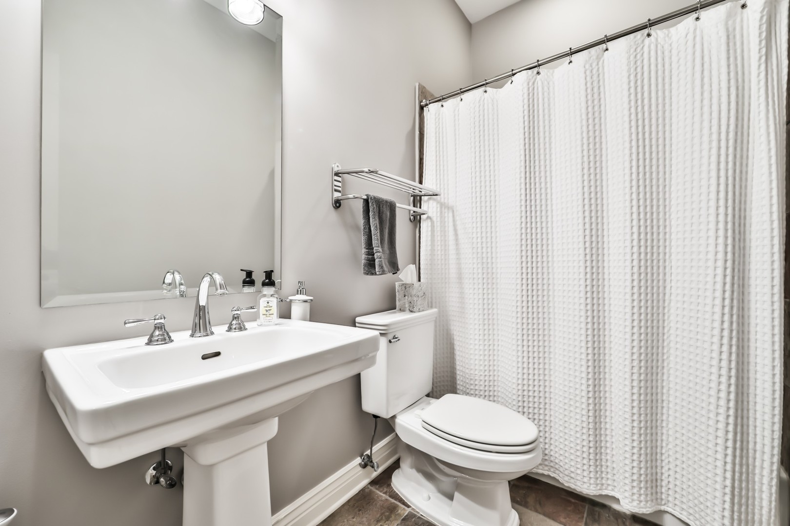 1148 West Monroe Street, Unit 5SE Chicago, IL 60607 - Photo 17 of 25 a bathroom with a sink a toilet and shower curtain
