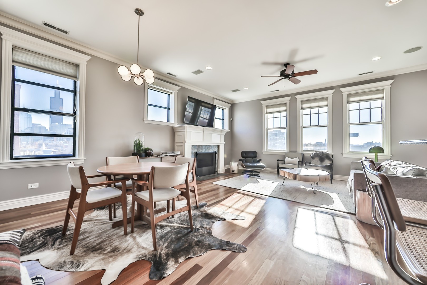 1148 West Monroe Street, Unit 5SE Chicago, IL 60607 - Photo 5 of 25 a view of a dining room and livingroom with furniture wooden floor a chandelier