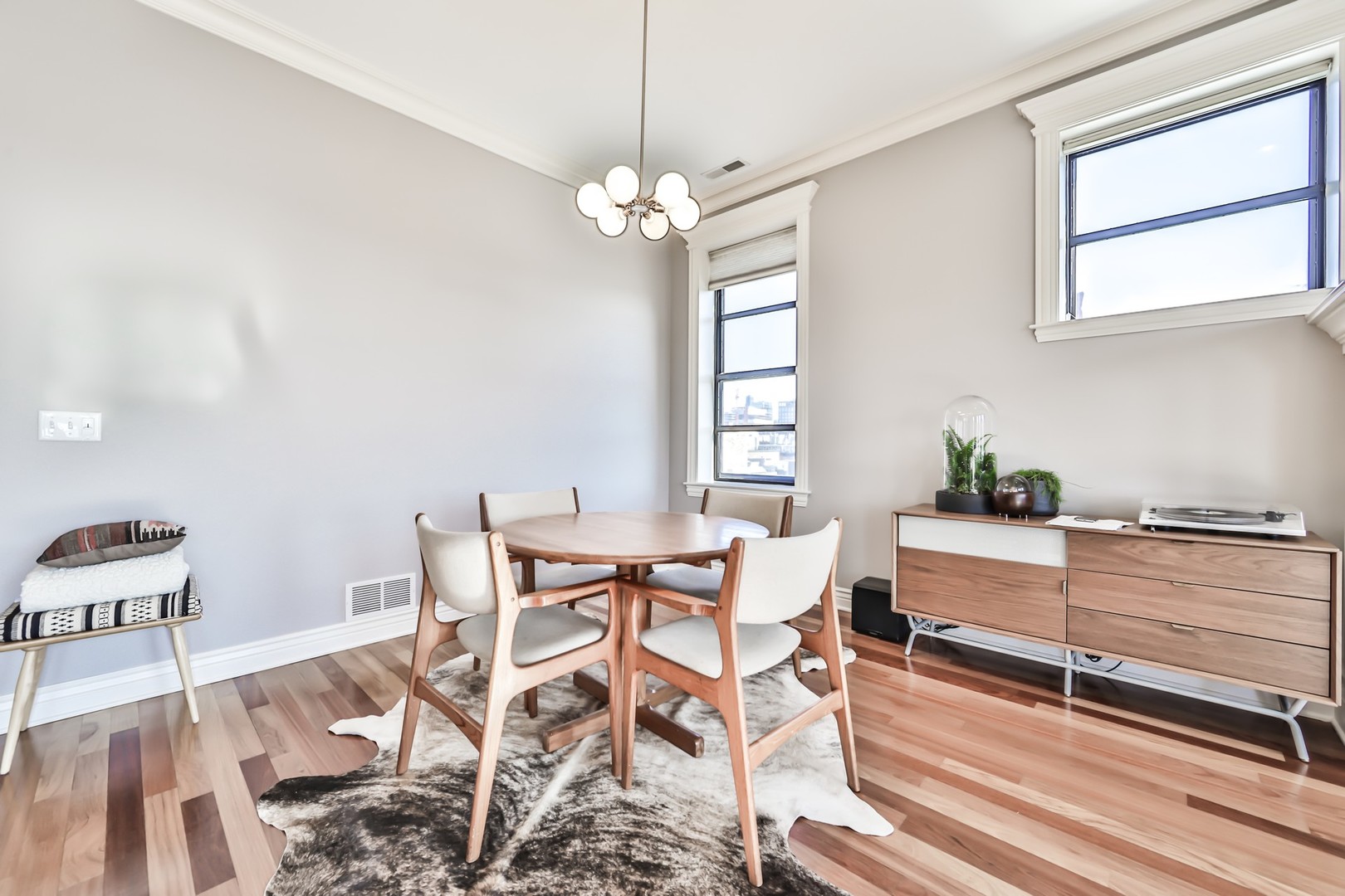 1148 West Monroe Street, Unit 5SE Chicago, IL 60607 - Photo 7 of 25 a dining room with wooden floor a chandelier a wooden table and chairs