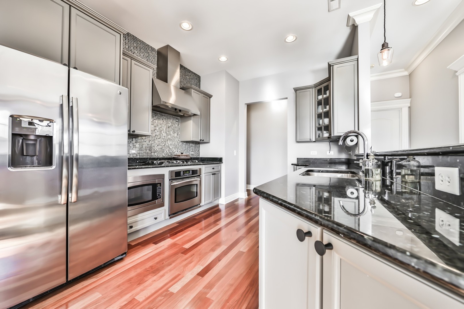 1148 West Monroe Street, Unit 5SE Chicago, IL 60607 - Photo 10 of 25 a kitchen with stainless steel appliances granite countertop a sink a stove and a refrigerator