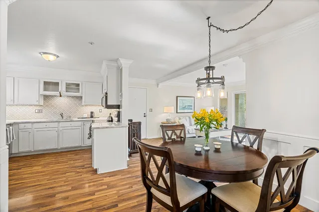 a view of a dining room with furniture and wooden floor