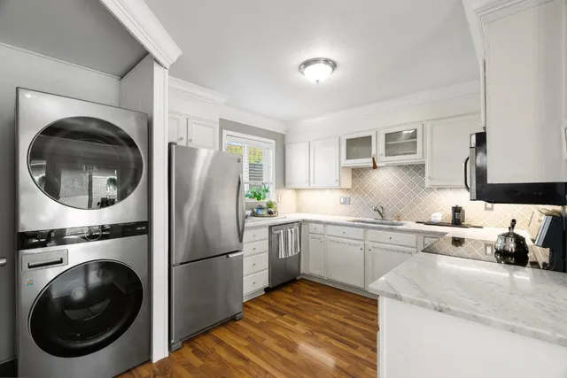 a kitchen with a sink cabinets and stainless steel appliances