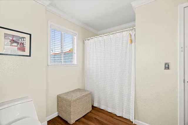 a room with a window and a wooden floor