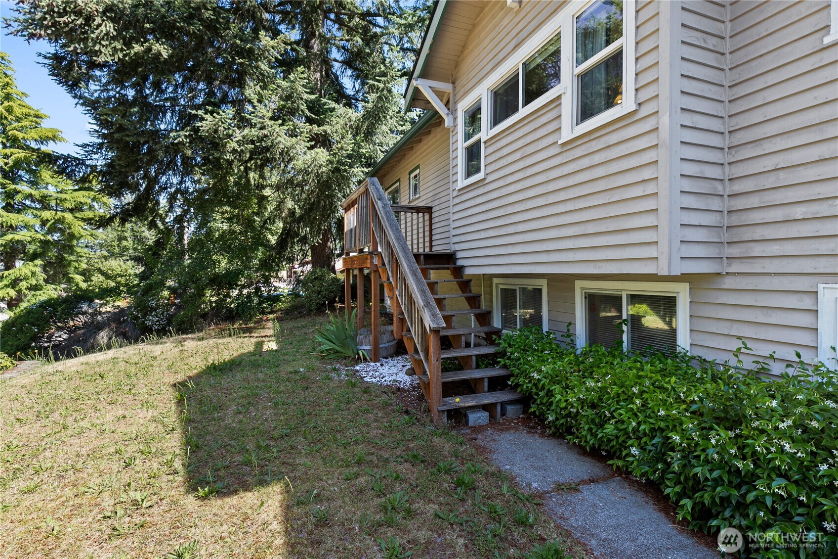 9880 Fredrickson Road Northwest Bremerton, WA 98311 - Photo 3 of 28 a view of a house with backyard porch and sitting area