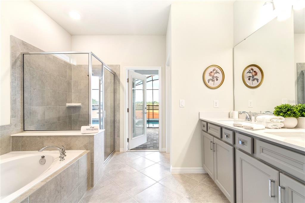 15972 Sandy Cliffs Drive Clermont, FL 34714 - Photo 28 of 85 a bathroom with a tub sink and mirror