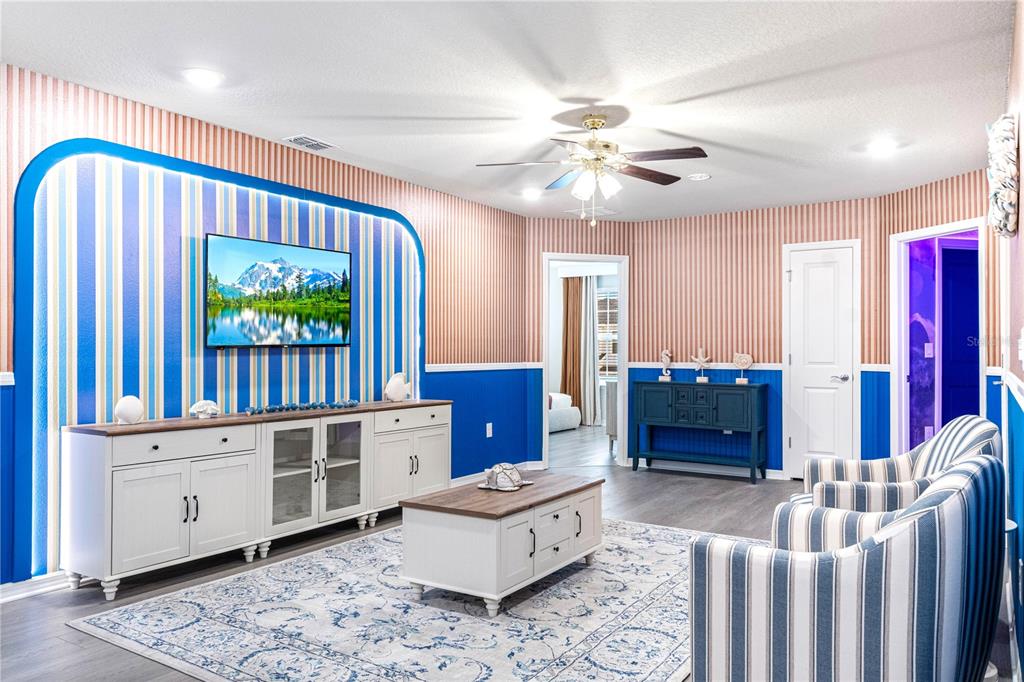15972 Sandy Cliffs Drive Clermont, FL 34714 - Photo 41 of 85 a living room with furniture and a flat screen tv