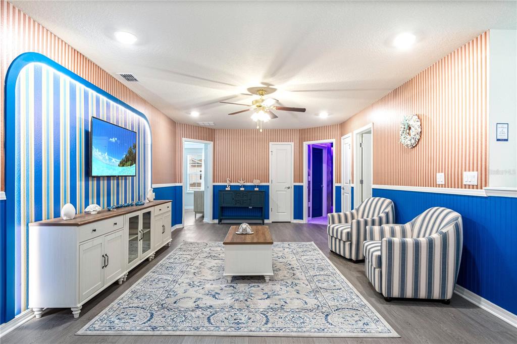 15972 Sandy Cliffs Drive Clermont, FL 34714 - Photo 42 of 85 a living room with furniture and wooden floor