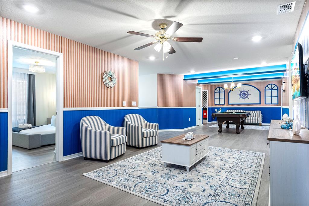 15972 Sandy Cliffs Drive Clermont, FL 34714 - Photo 43 of 85 a living room with furniture and a large window