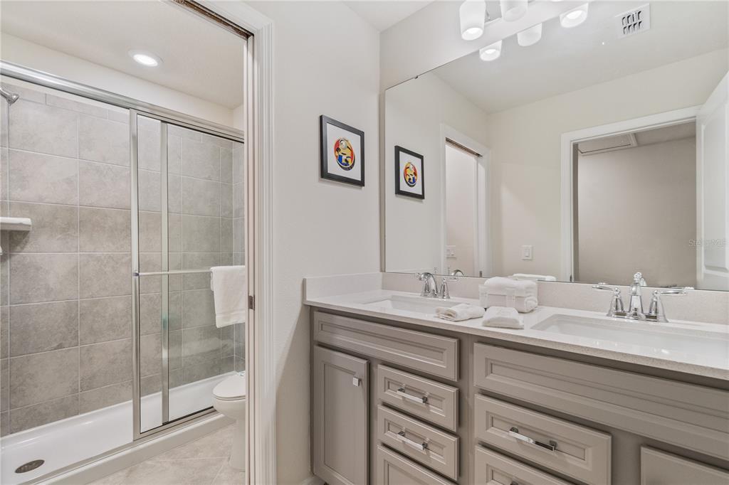 15972 Sandy Cliffs Drive Clermont, FL 34714 - Photo 60 of 85 a bathroom with 2 sink and a mirror