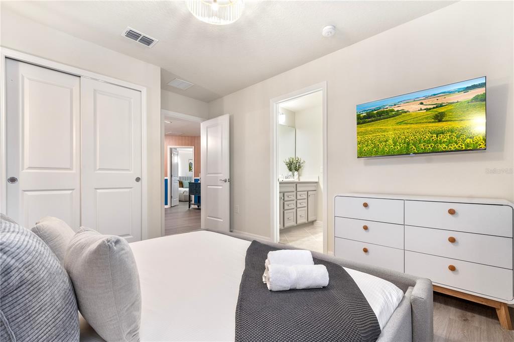 15972 Sandy Cliffs Drive Clermont, FL 34714 - Photo 70 of 85 a bedroom with a bed and a flat screen tv