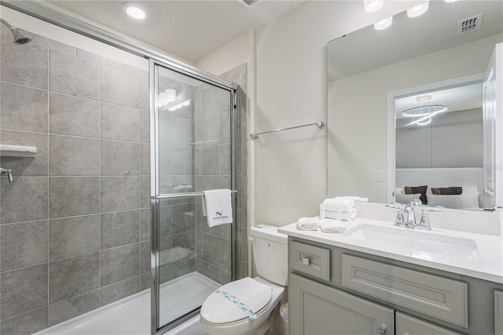 15972 Sandy Cliffs Drive Clermont, FL 34714 - Photo 75 of 85 a bathroom with a sink a toilet and shower
