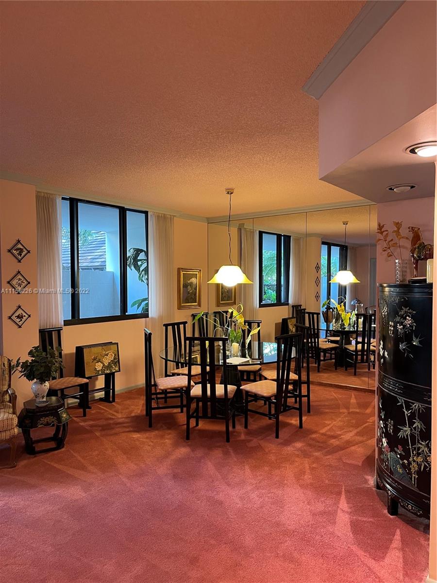520 Brickell Key Drive, Unit A306 Miami, FL 33131 - Photo 5 of 5 a living room with furniture and a dining table with chair