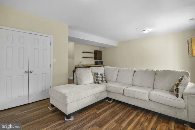 a living room with a couch and a rug