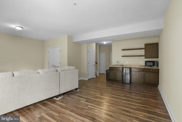 a large white kitchen with a stove a sink dishwasher and a refrigerator