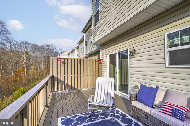 a balcony with wooden floor outdoor seating and city view