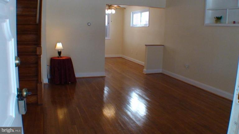 1921 Jasmine Road Dundalk, MD 21222 - Photo 2 of 9 a view of a livingroom with wooden floor and a window