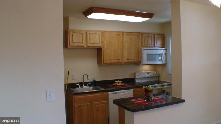 1921 Jasmine Road Dundalk, MD 21222 - Photo 4 of 9 a kitchen with a sink and cabinets