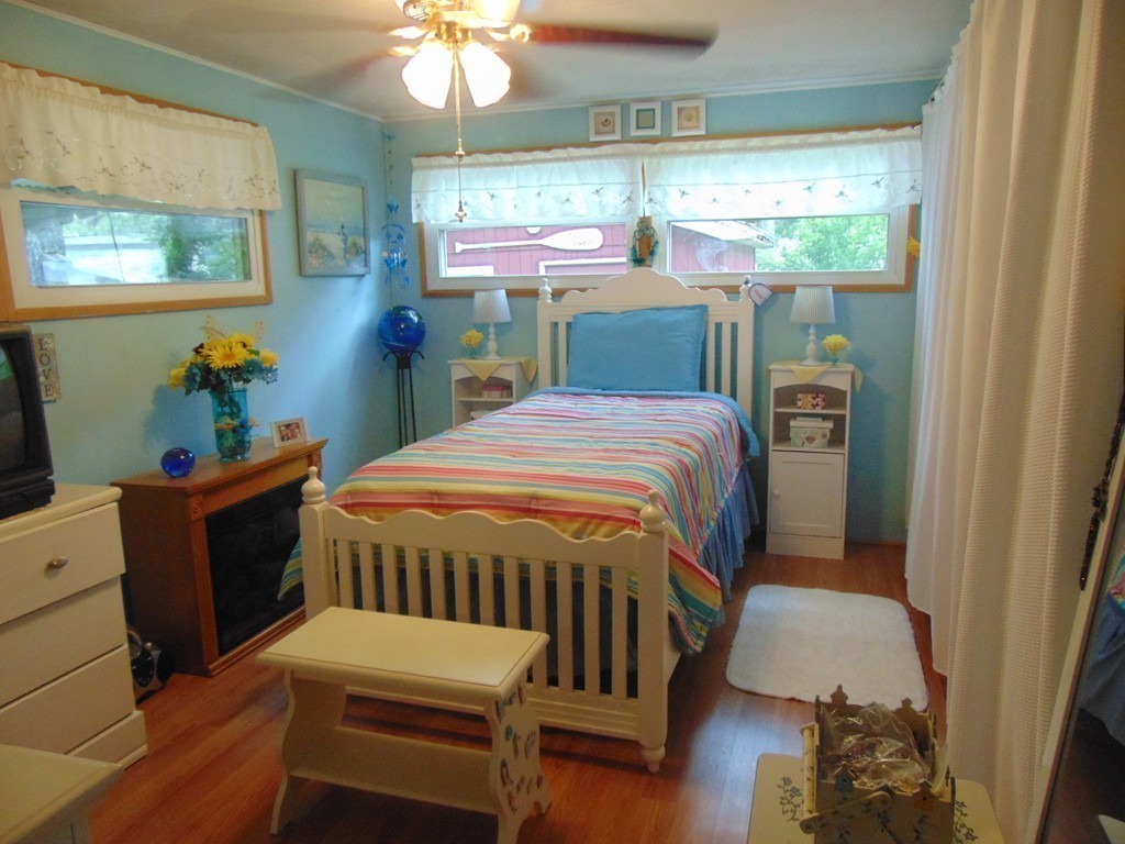 3132 Cranberry Highway, Unit 56 Wareham, MA 02538 - Photo 19 of 20 a bed sitting in a bedroom next to a window